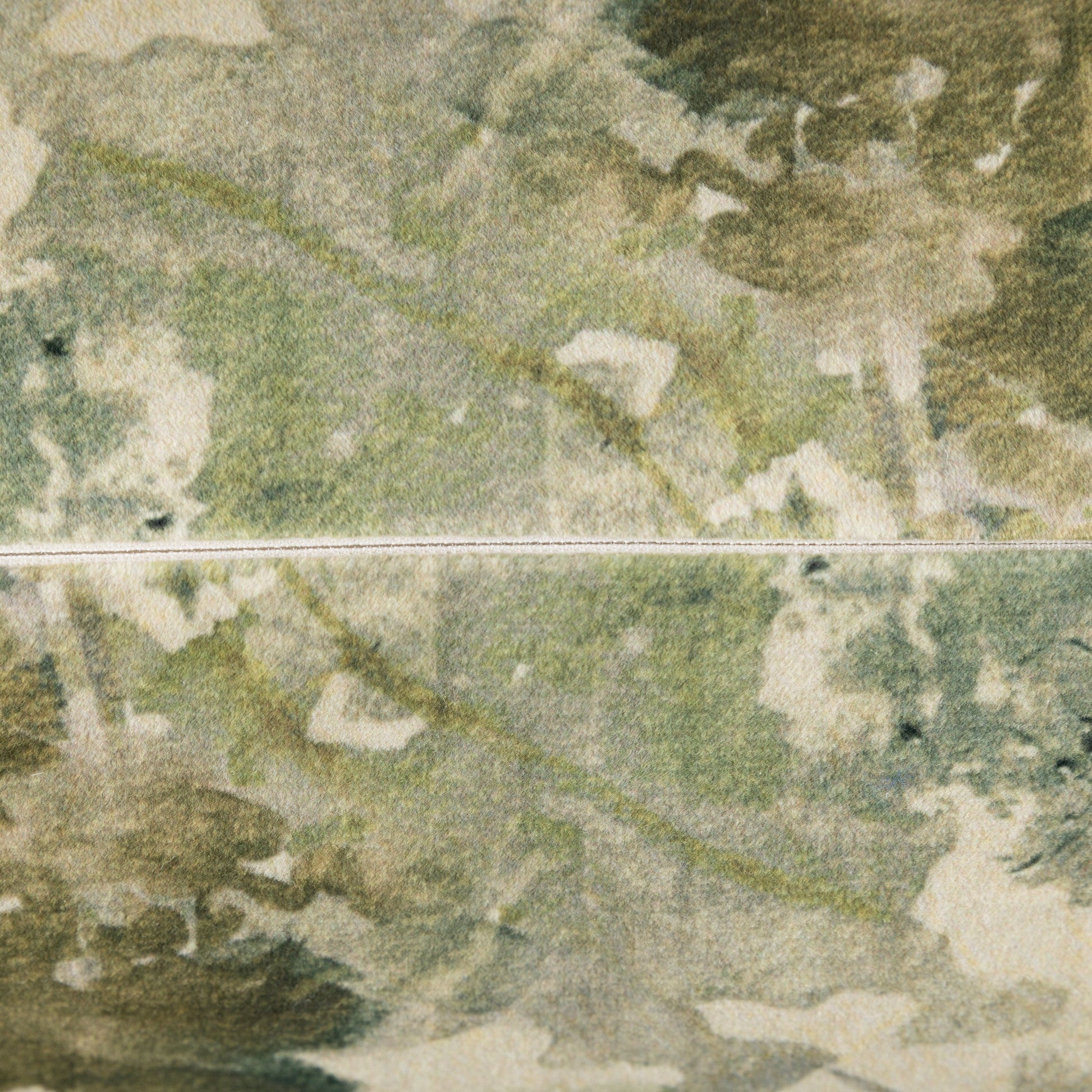 Close-up of a textured green surface with a zip