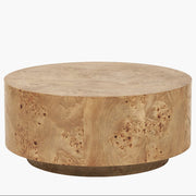 Round wooden coffee table with a natural finish on a white background