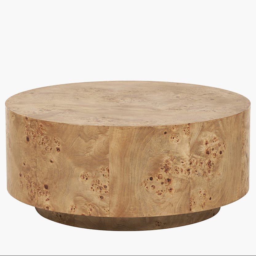 Round wooden coffee table with a natural finish on a white background
