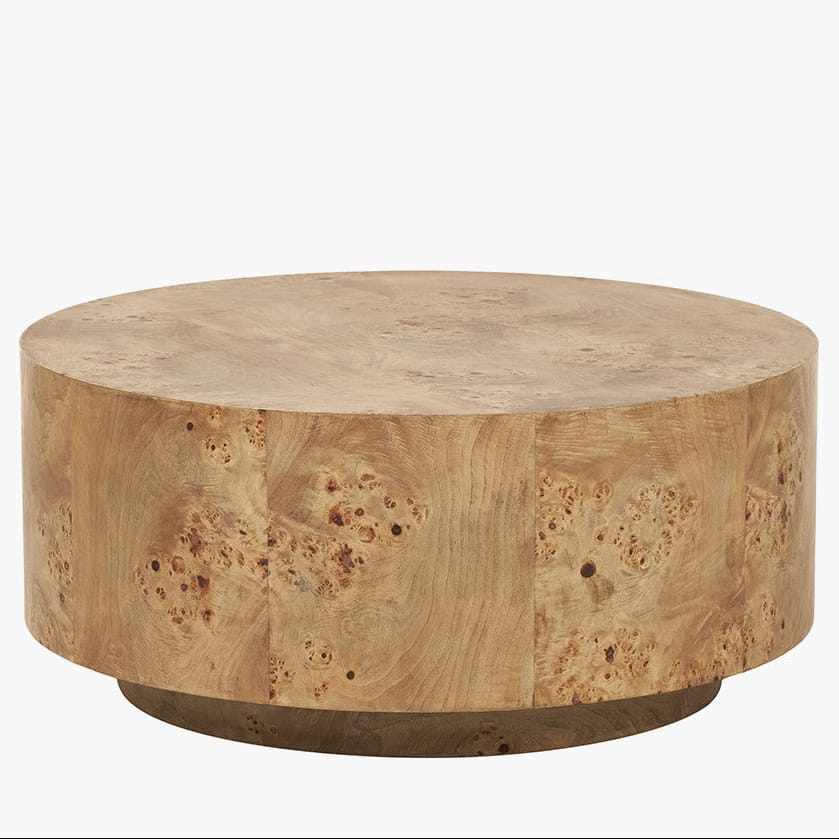 Round wooden coffee table with a natural finish on a white background