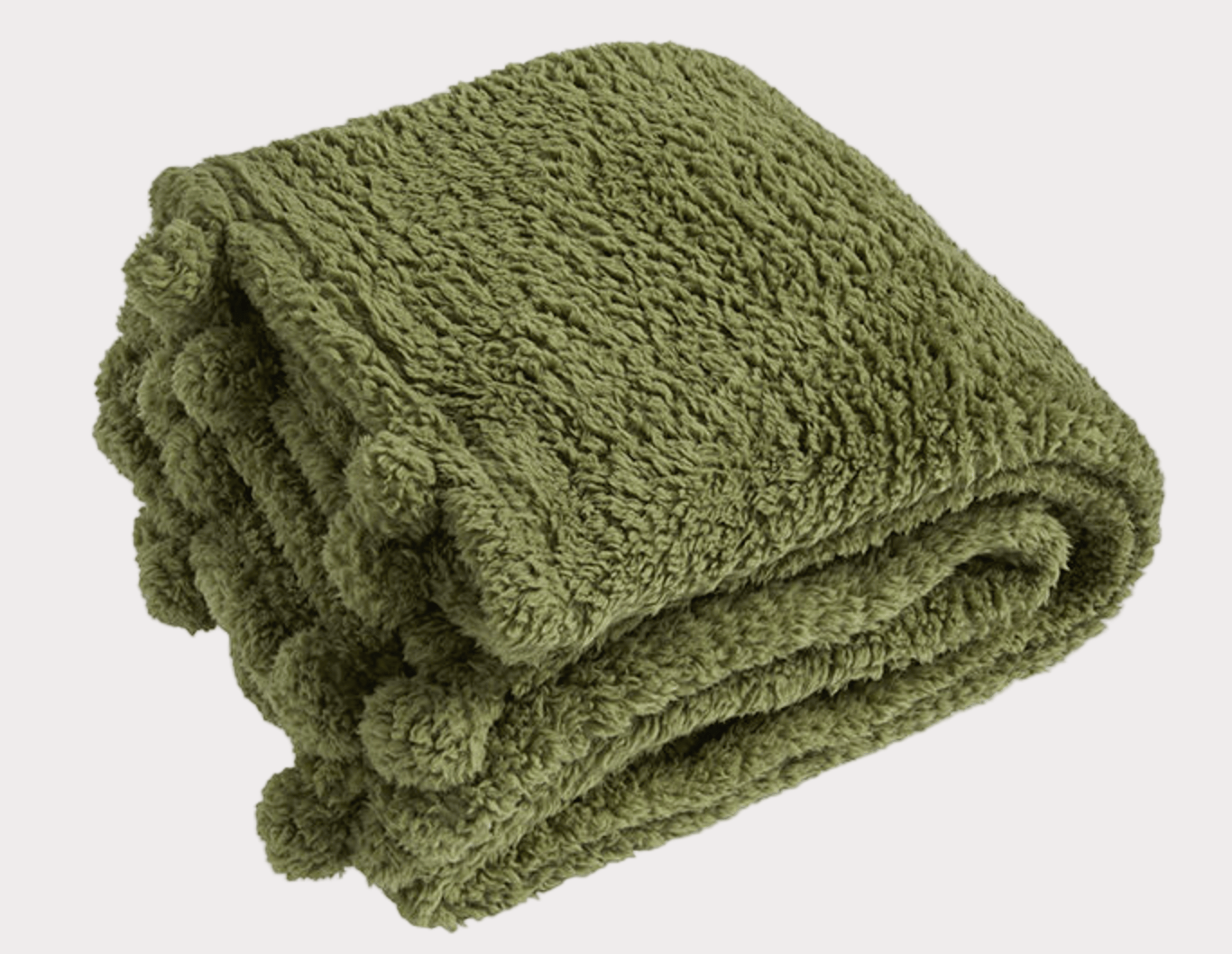 Folded green blanket with pom-pom details on a white background