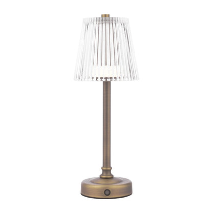 A rechargeable table lamp with a antique brass base and a white pleated shade.