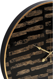 Wall clock with black and gold design on a white background