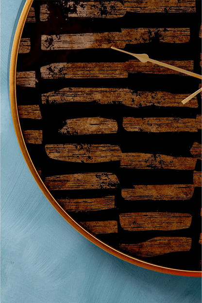 black and gold clock with a rustic design on a blue background