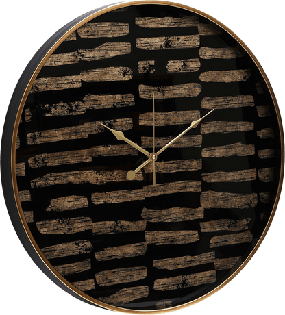 Round wall clock with black and gold patterned face on a white background
