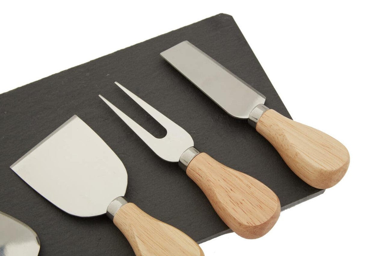 Set of three cheese tools with wooden handles on a black slate board.