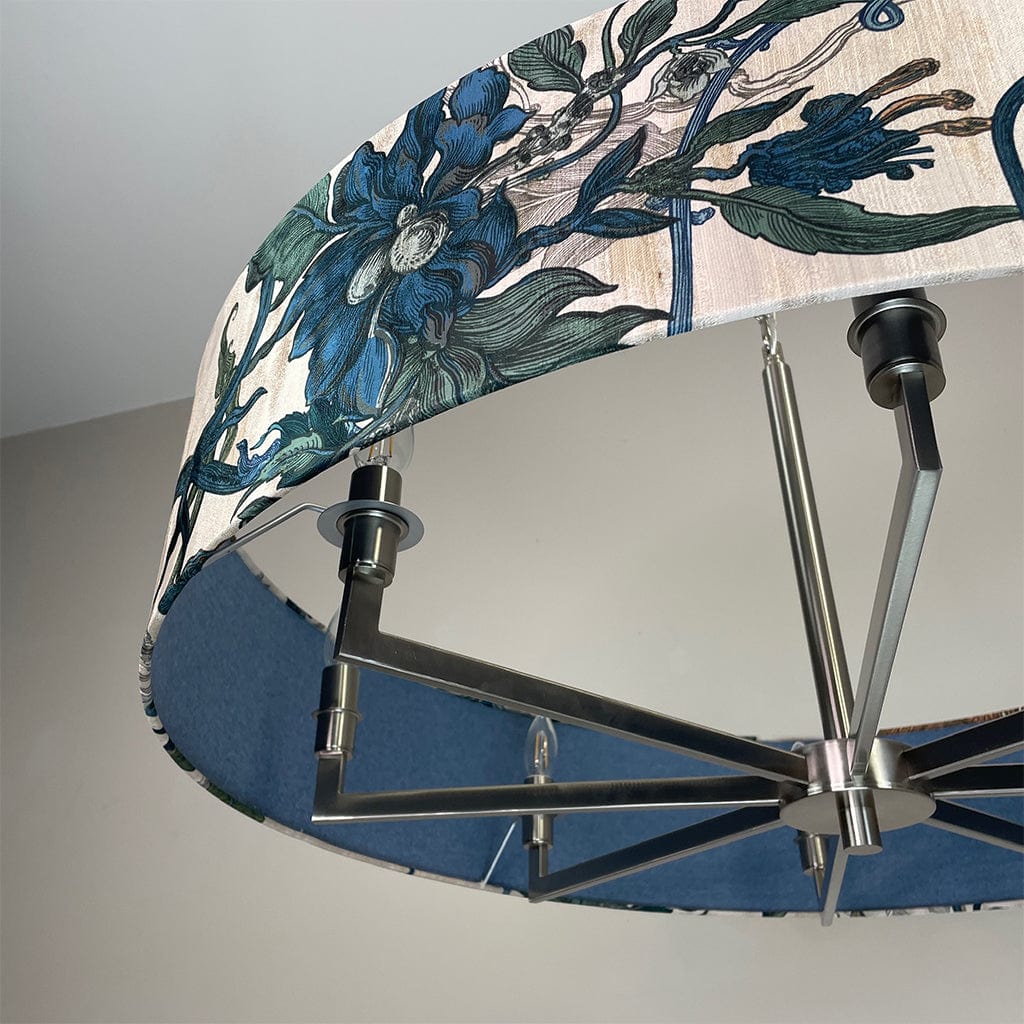 Ceiling light fixture with floral design on the shade against a neutral background