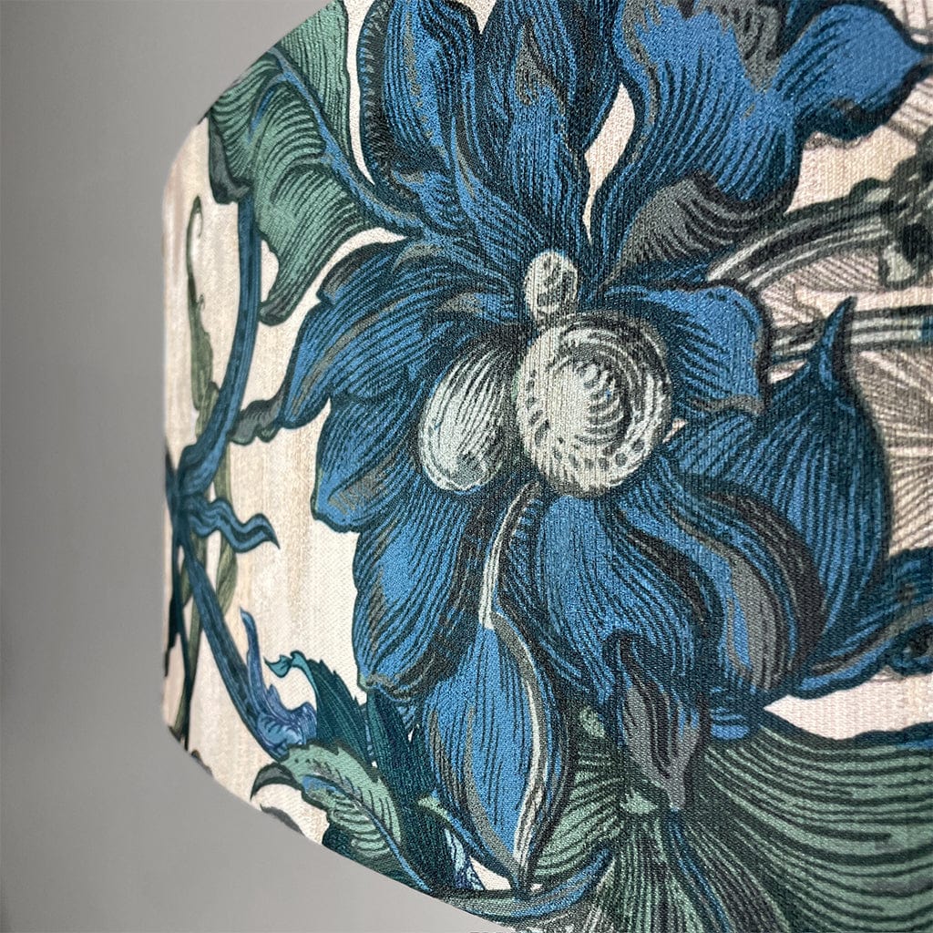 Close-up of a floral pattern with blue and green colors on a textured surface.