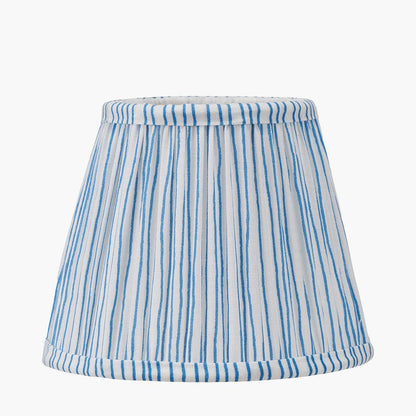 Striped lampshade with blue and white pattern on a white background
