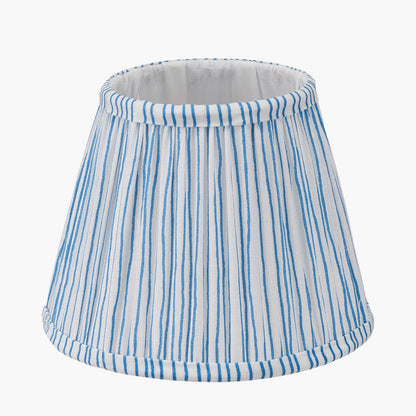 Striped lampshade with blue and white pattern on a white background