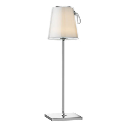 A slim chrome table lamp with a clear ivory lampshade and a touch-sensitive switch on the side.