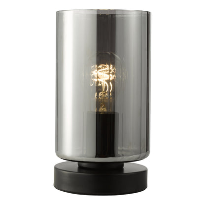 Table lamp with smoked glass shade and black base on a white background