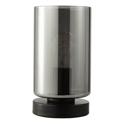 Smoky gray cylindrical lamp with black base on a white background