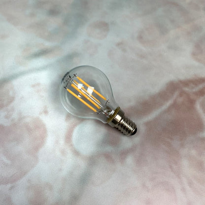 A clear, small Edison screw fitting LED golfball light bulb.