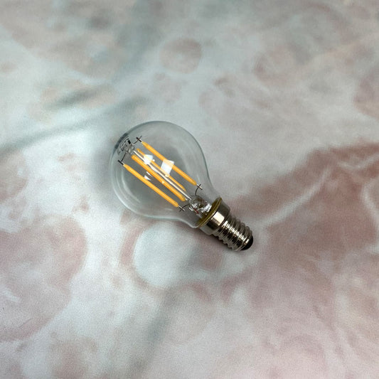 A clear, small Edison screw fitting LED golfball light bulb.