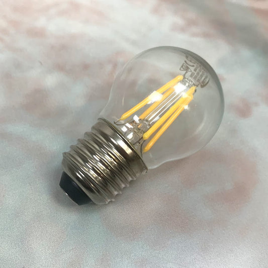 A clear E27 6.5W non-dimmable LED golfball-shaped light bulb with a silver E27 base.