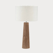 Table lamp with wooden base and white textured shade on a white background