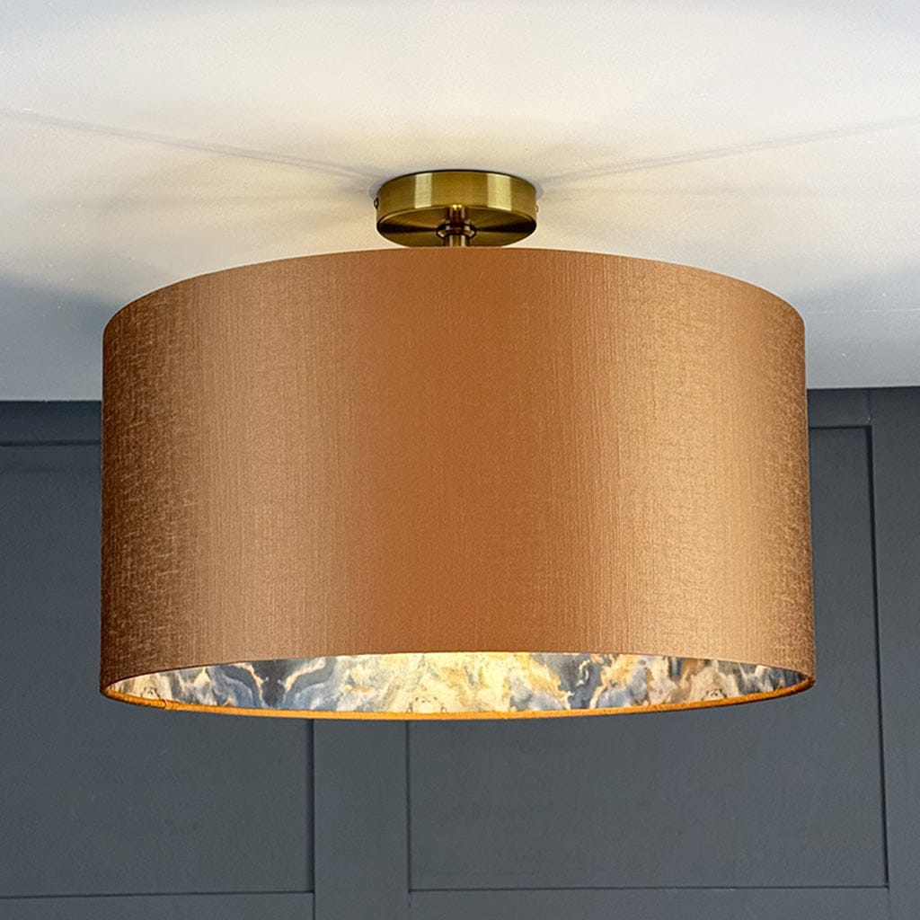 Ceiling light fixture with a brown lampshade against a gray wall.