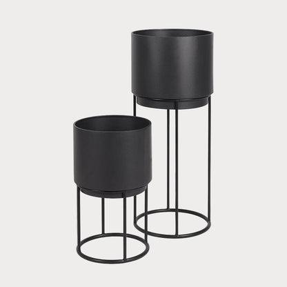 Two black circular planters with metal stands, one large and one small, displayed against a white background.