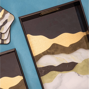 Decorative trays with marble-like design on a blue background