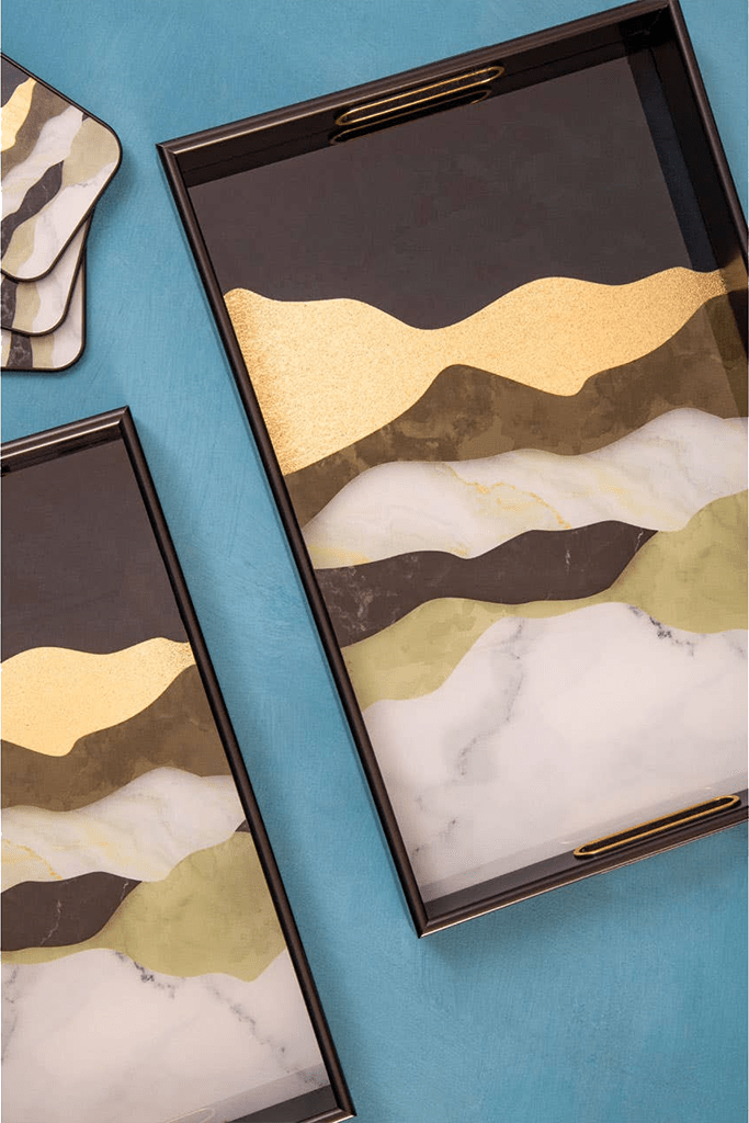 Decorative trays with marble-like design on a blue background