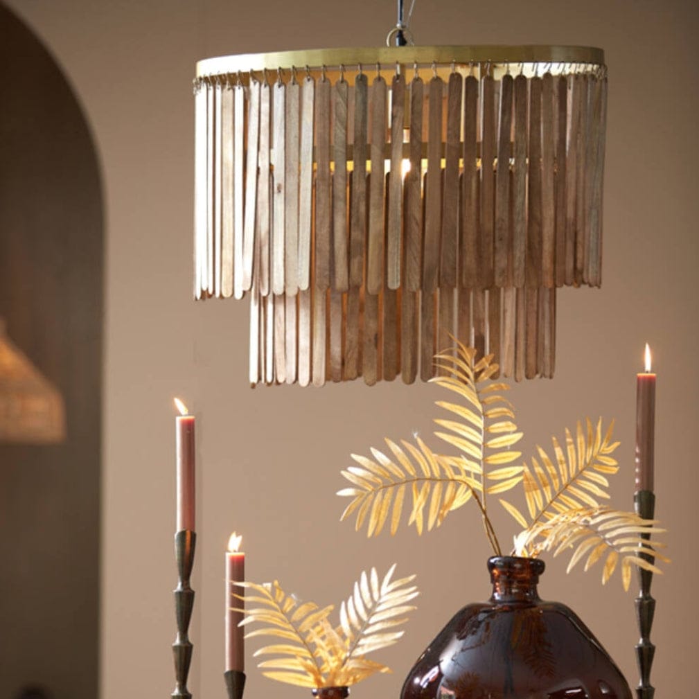 Dining room with a wooden table, decorative vases, candles, and a chandelier.