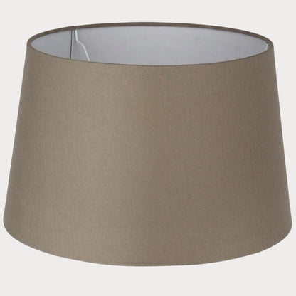 A taupe-colored, cotton handloom tapered cylinder lamp shade.