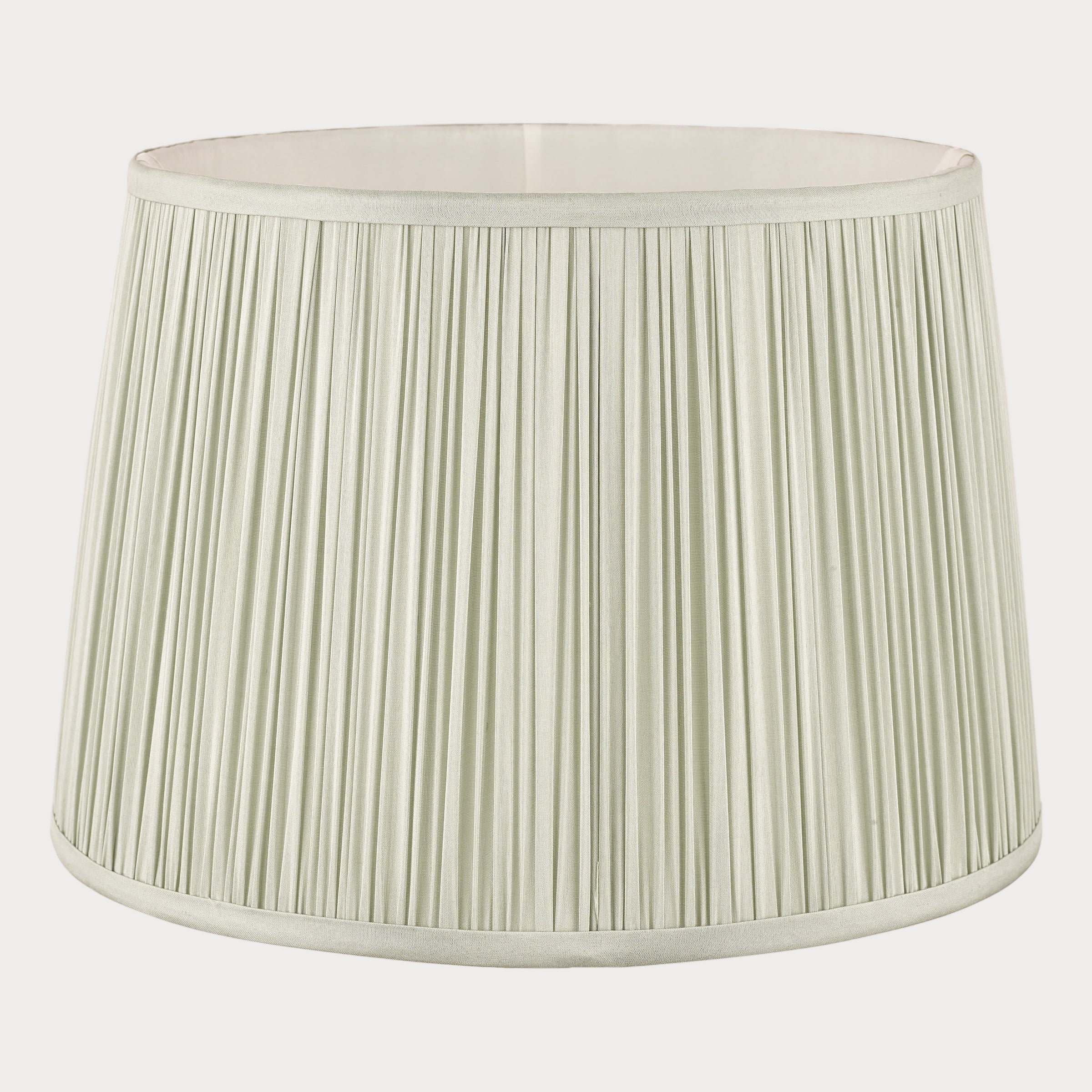 Light green pleated lampshade on a white background