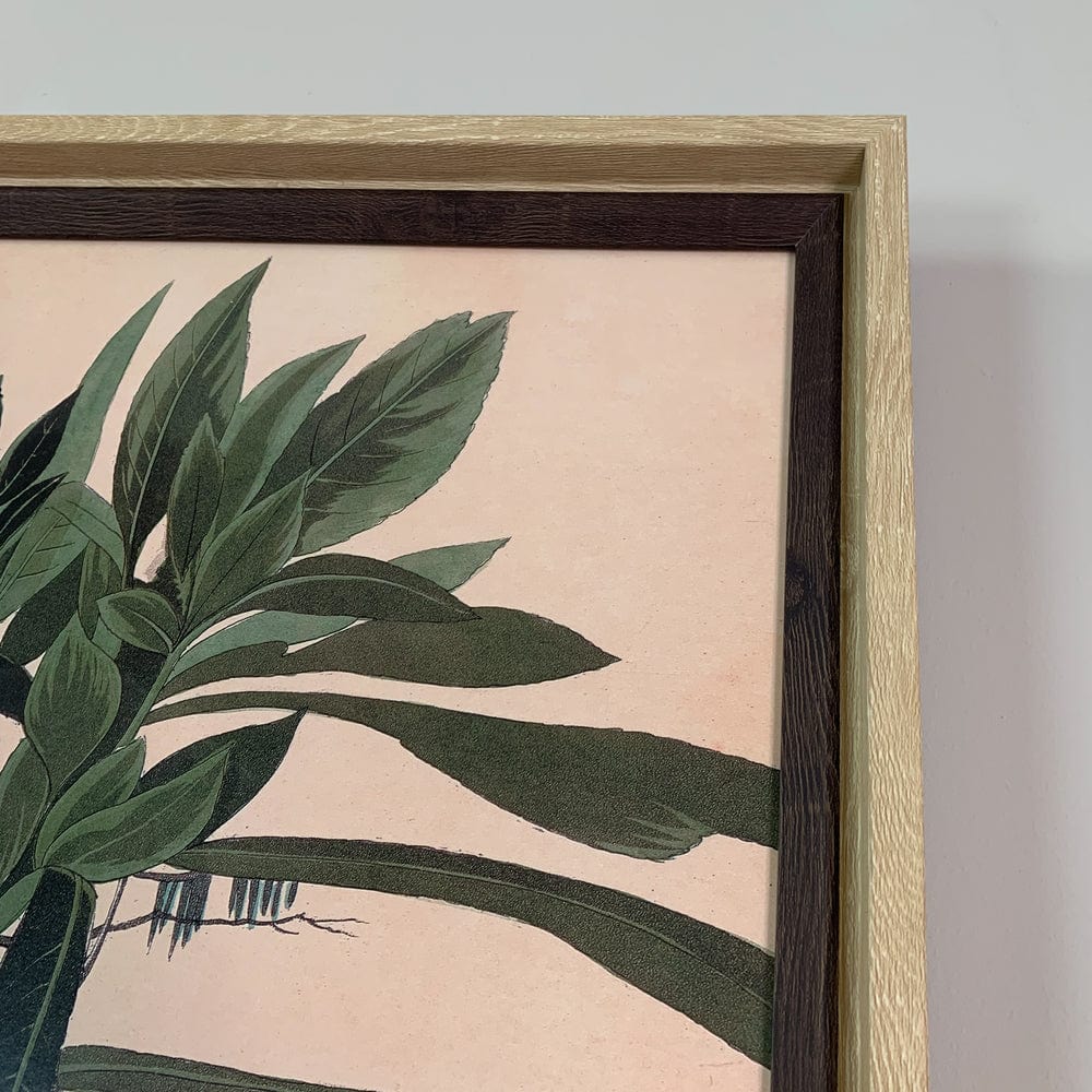 Framed artwork with green leaf design on a beige background