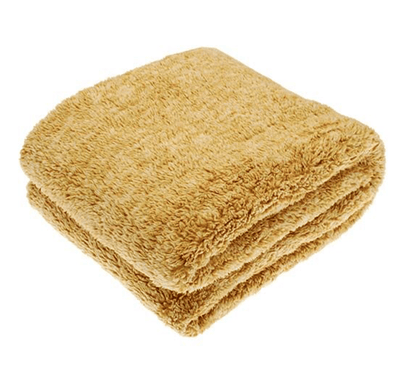 Folded beige throw on a white background