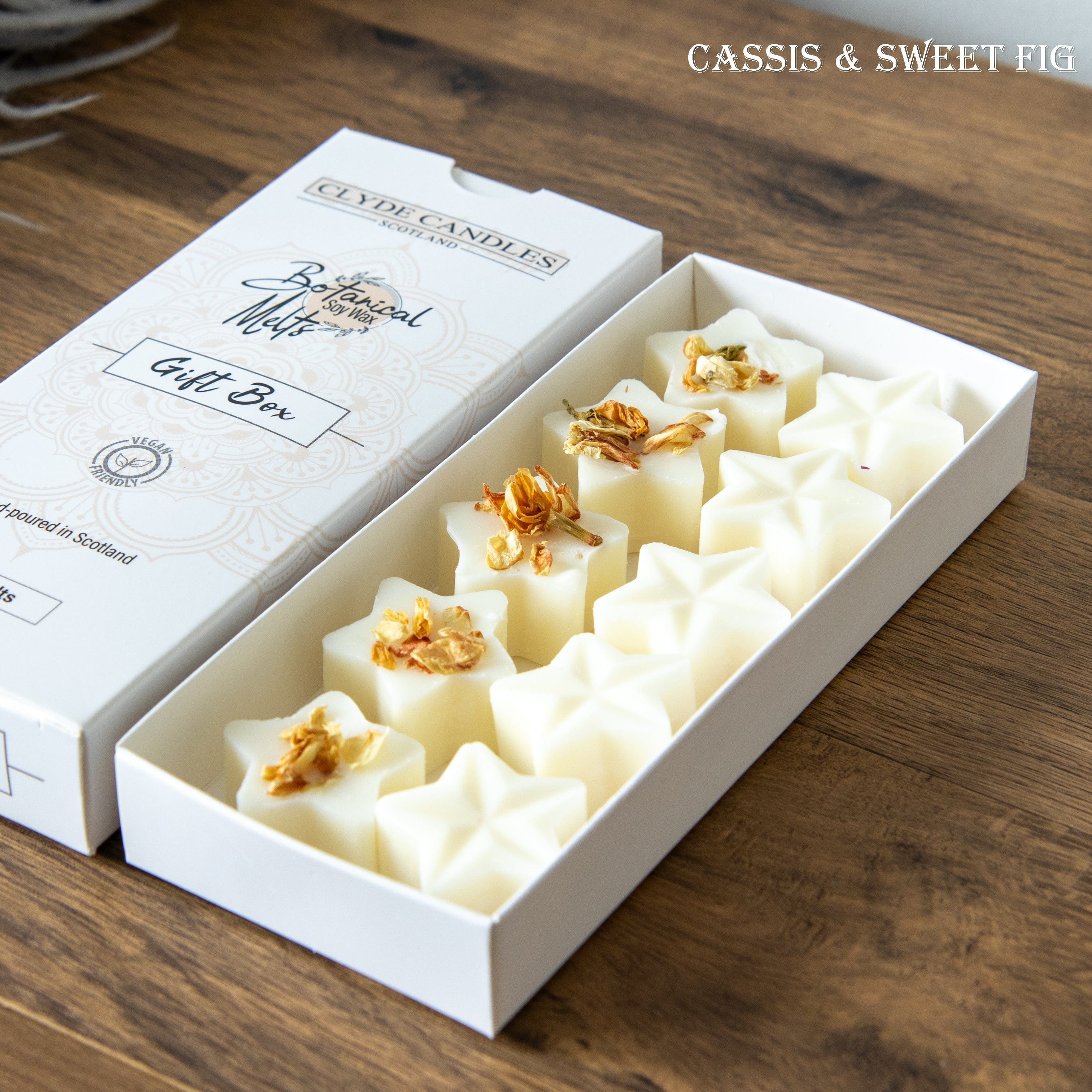 Box of Clyde Candles gift set on a wooden surface