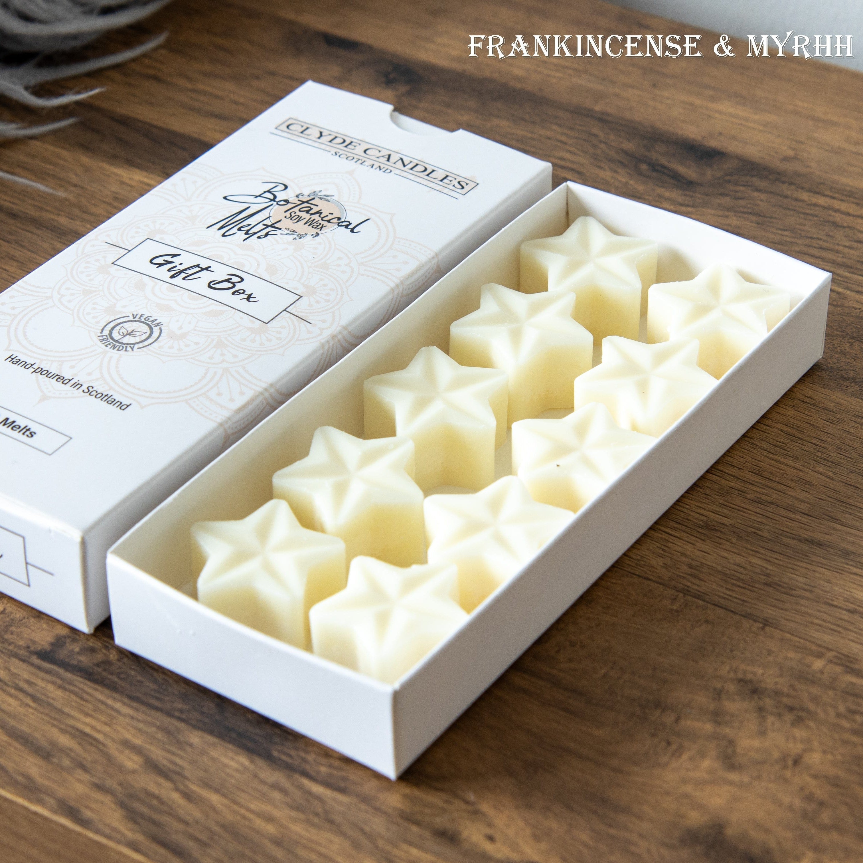 Box of star-shaped candles with a white box on a wooden surface, featuring 'Ceylon Candles' branding.