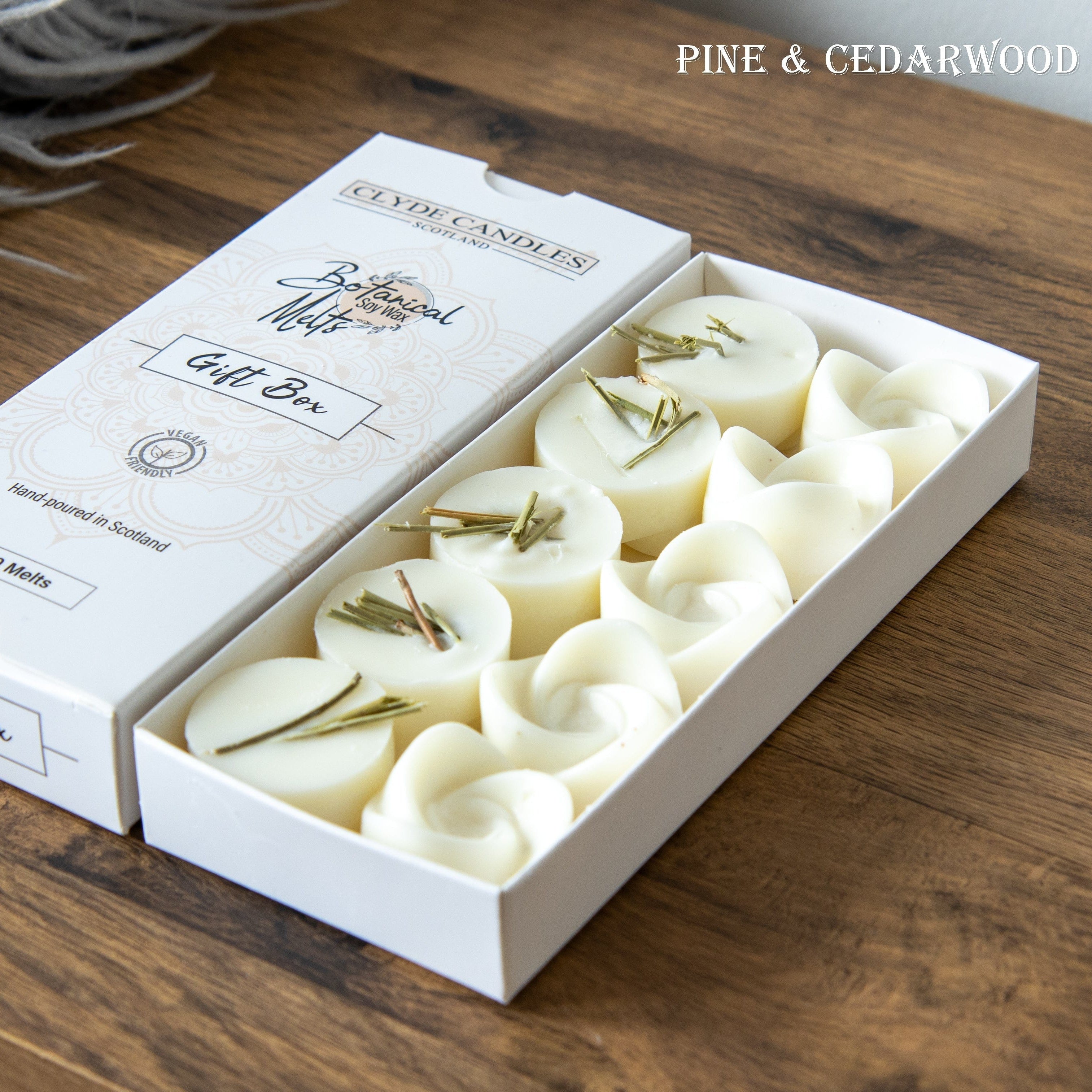 Box of candles with pine and cedarwood fragrance on a wooden surface
