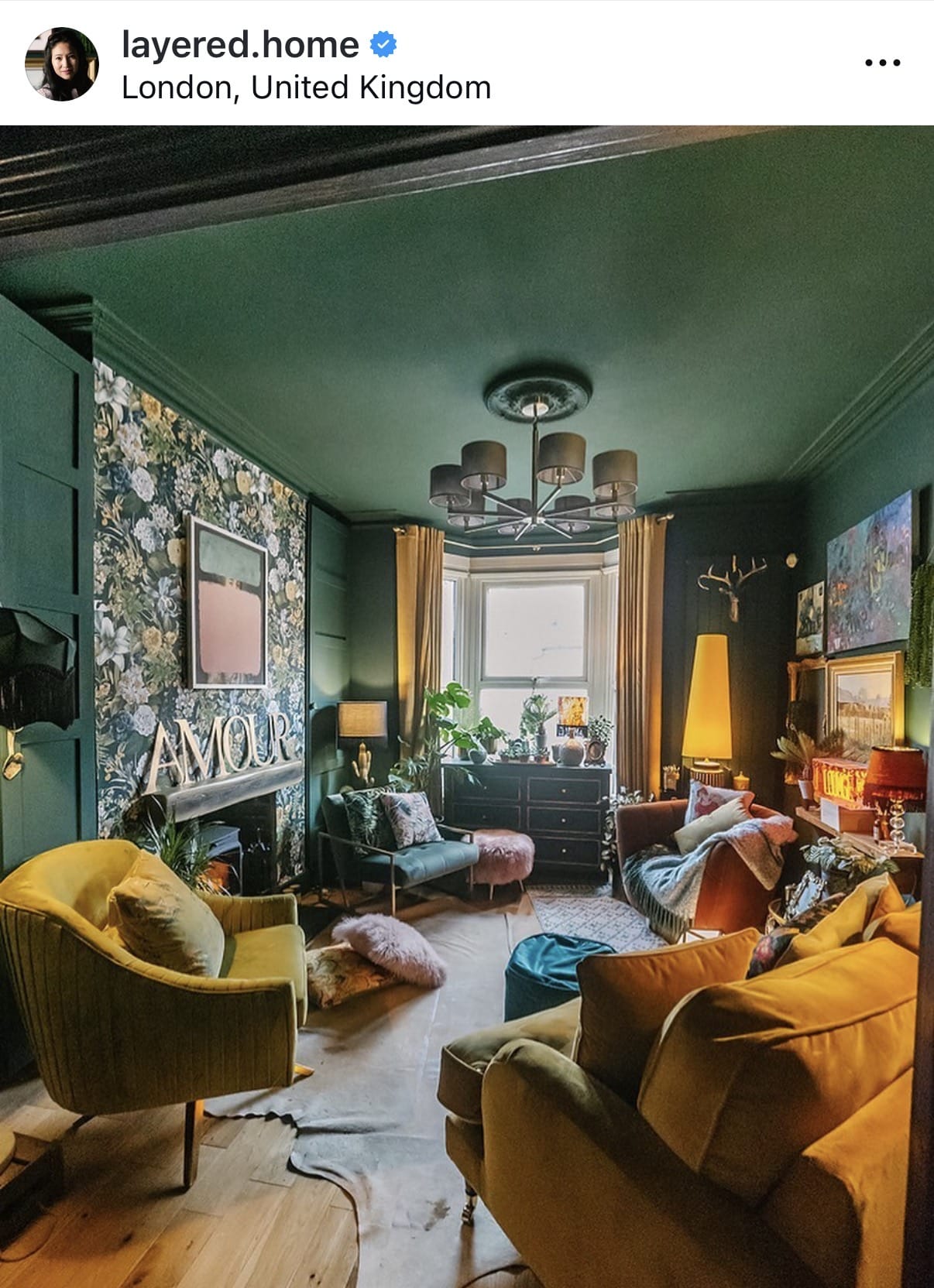 Living room with green walls, yellow armchair, and brown sofa.