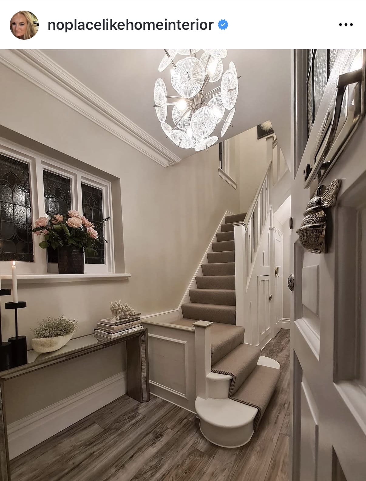 Staircase in a home with decorative elements and a chandelier.