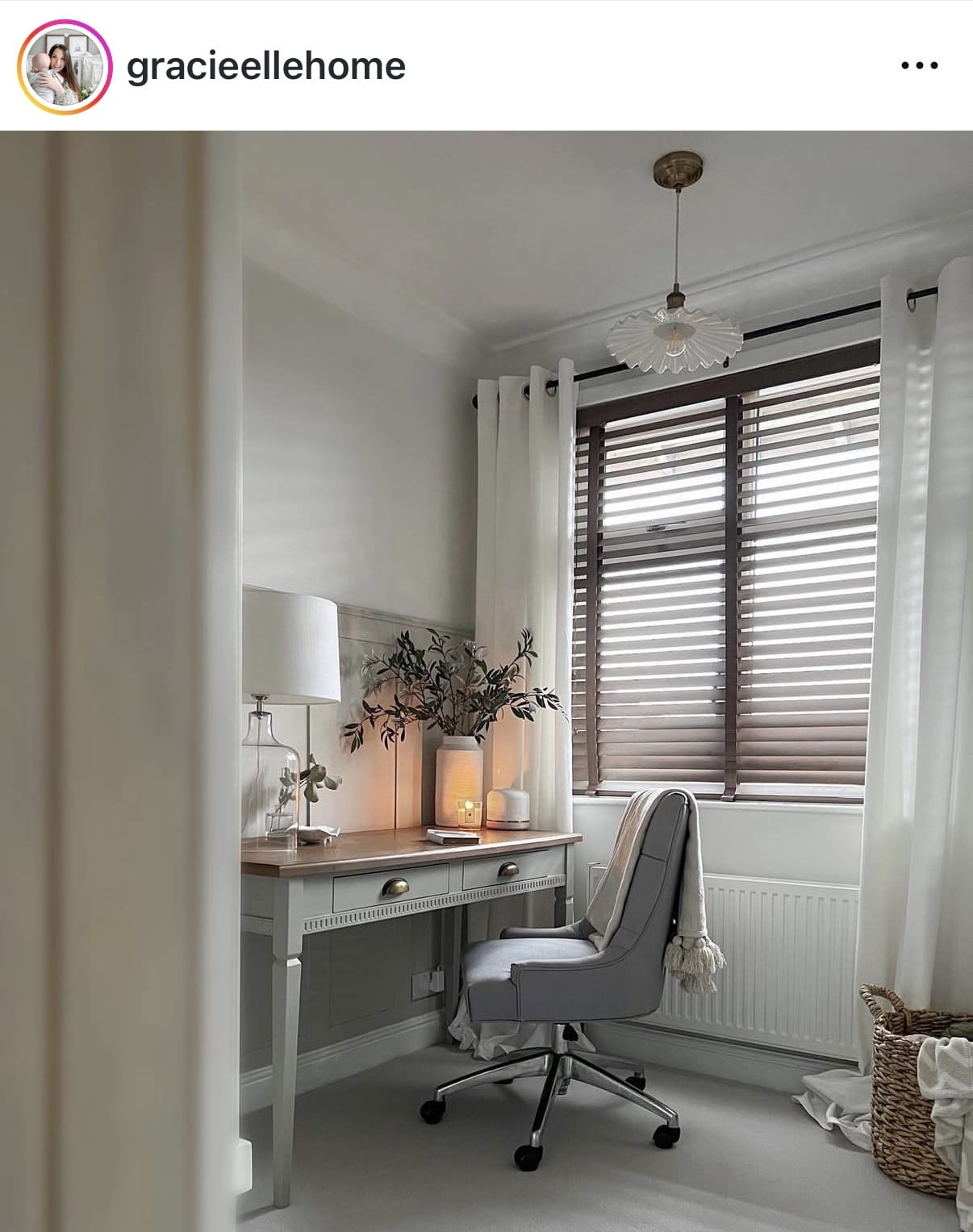 Home office with a desk, chair, and decorative elements.