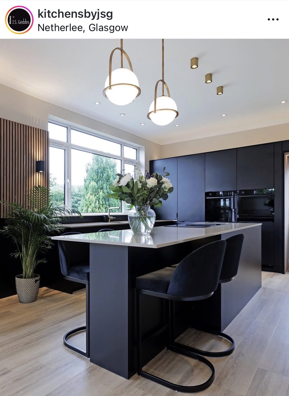 Modern kitchen with a island, chairs, and large windows in Netherlee, Glasgow.