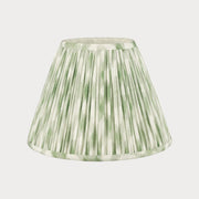 Green pleated lampshade on a white background