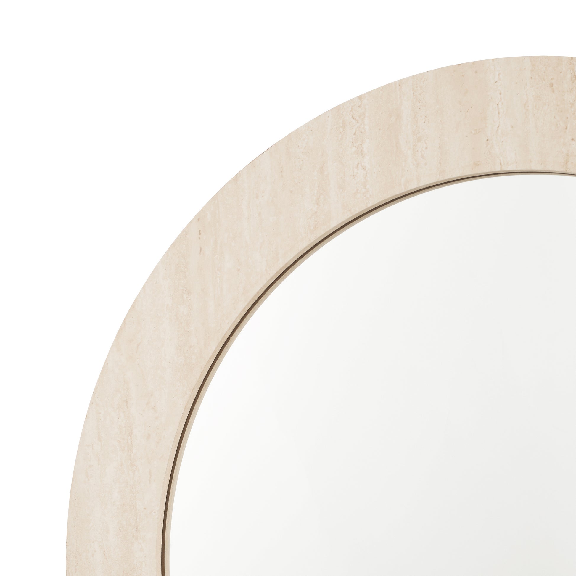 Close-up of a round mirror with a beige frame on a white background