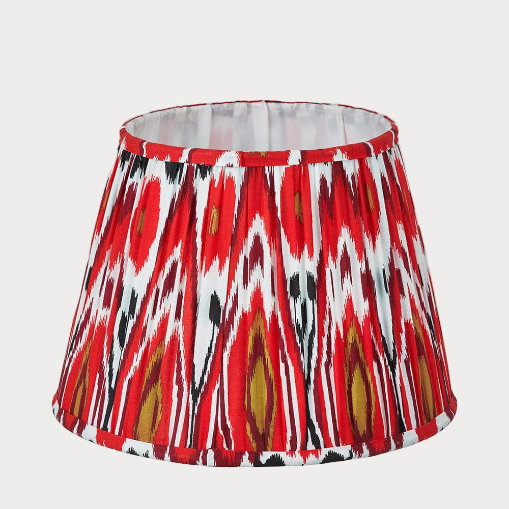 Red, white, and black patterned lampshade on a white background