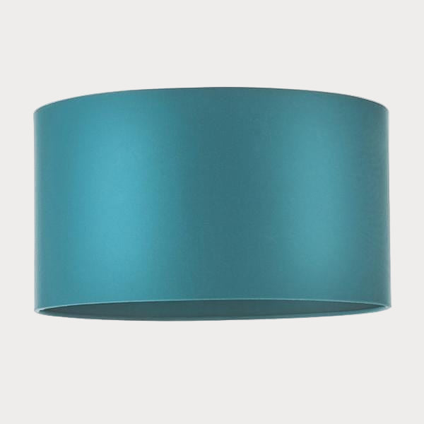 A drum-shaped teal satin lampshade with a rolled edge.