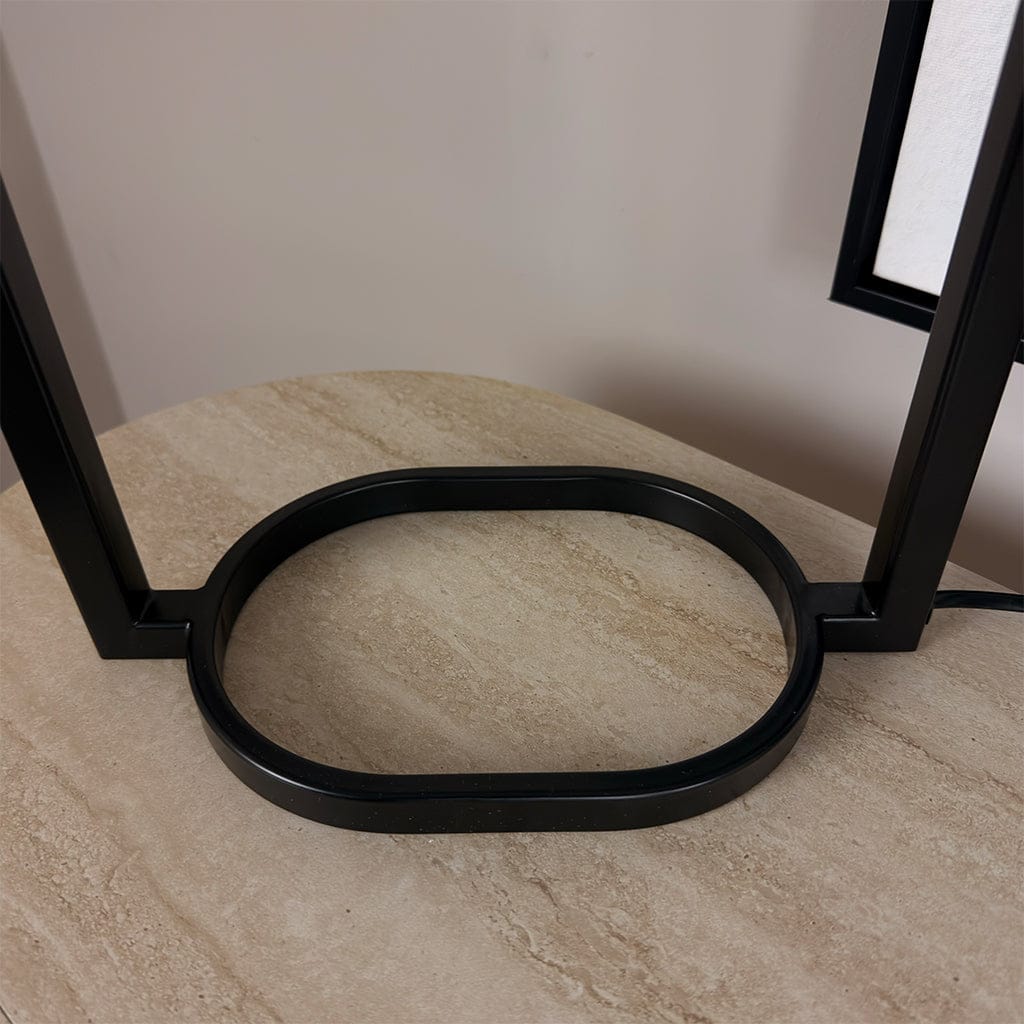 Black metal ring on a marble surface with a neutral background