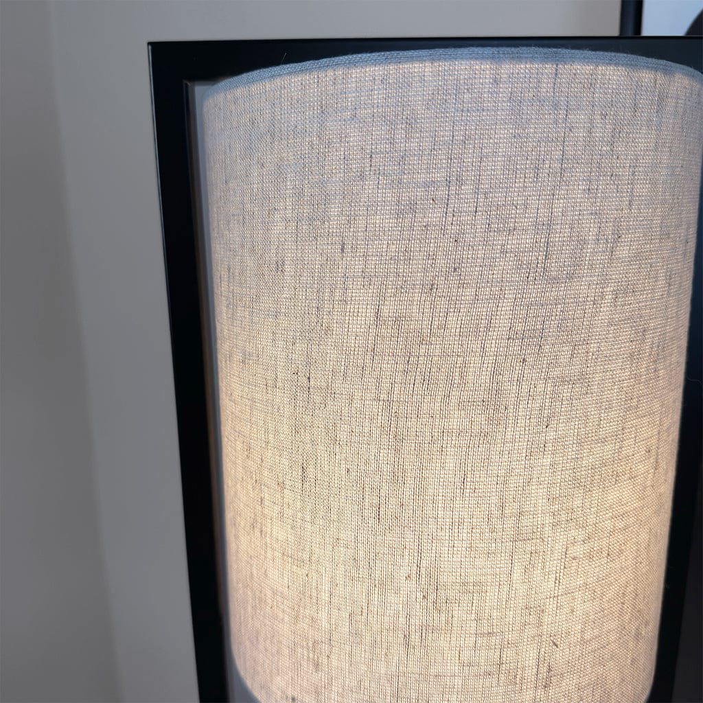 Close-up of a textured lampshade with a black frame on a neutral background
