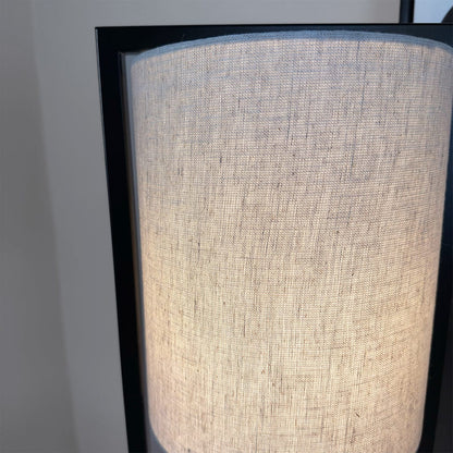 Close-up of a textured lampshade with a black frame on a neutral background