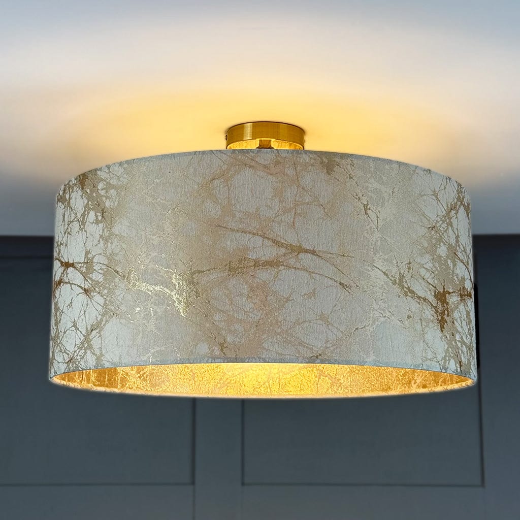 Ceiling light fixture with marble patterned shade on a dark background