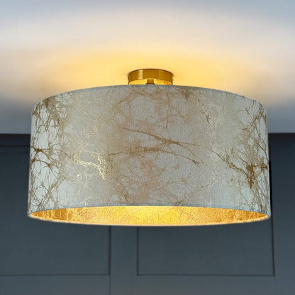 Ceiling light fixture with marble patterned shade on a dark background