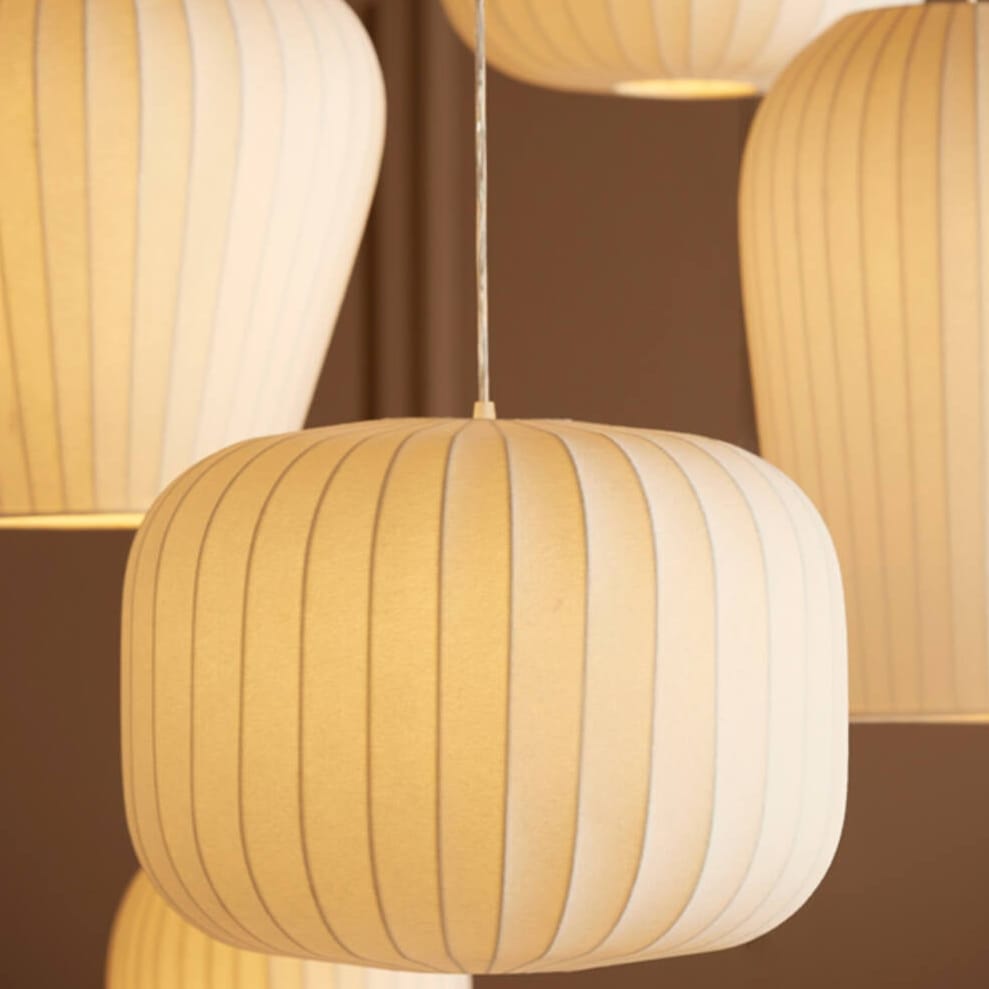 String of round, striped pendant lights against a brown background