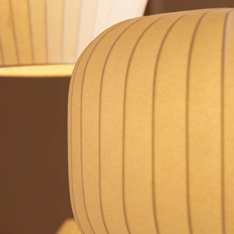Close-up of a textured yellow parchment lampshade with a blurred background