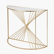 A half moon console table with a gold leaf metal framework and a glass tabletop.