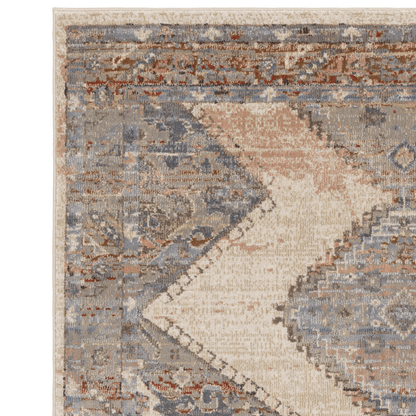 A persian style rug on a white background made up of blues, beiges and red accents